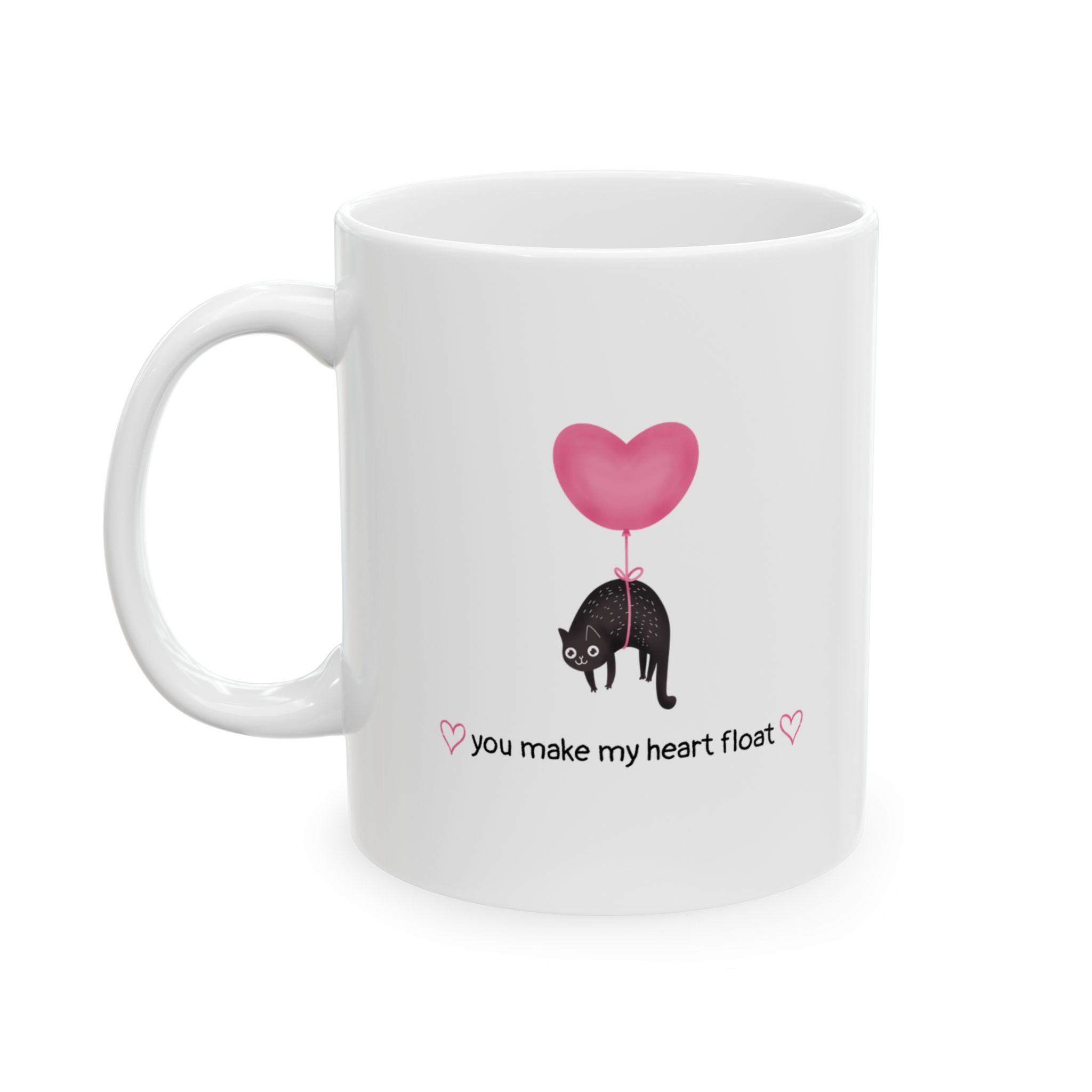 Isolated cat lover mug that says "you make my heart float" with handle on the left