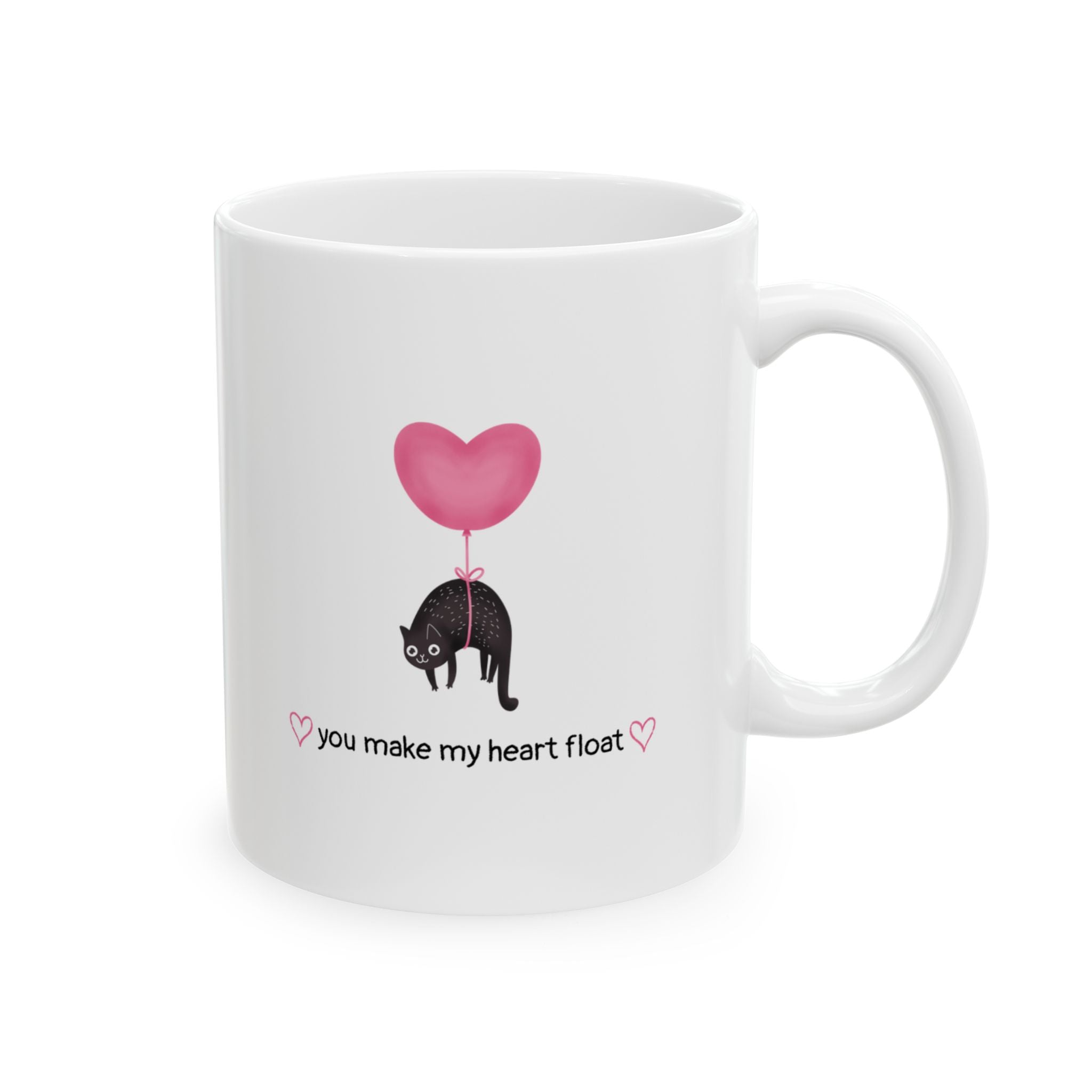 Isolated cat lover mug that says "you make my heart float" with handle on the right