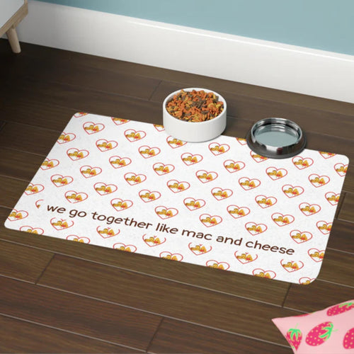 Pet mat with mac and cheese pattern and text on a wooden floor